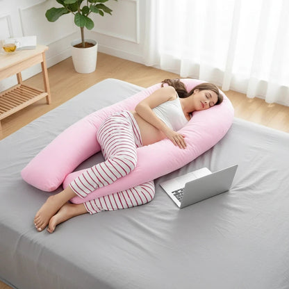 EVEREASE pink U-shaped full body maternity pillow supporting a pregnant woman sleeping comfortably on a bed