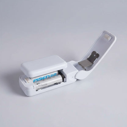 EVEREASE portable handheld plastic bag heat sealer in white with open battery compartment