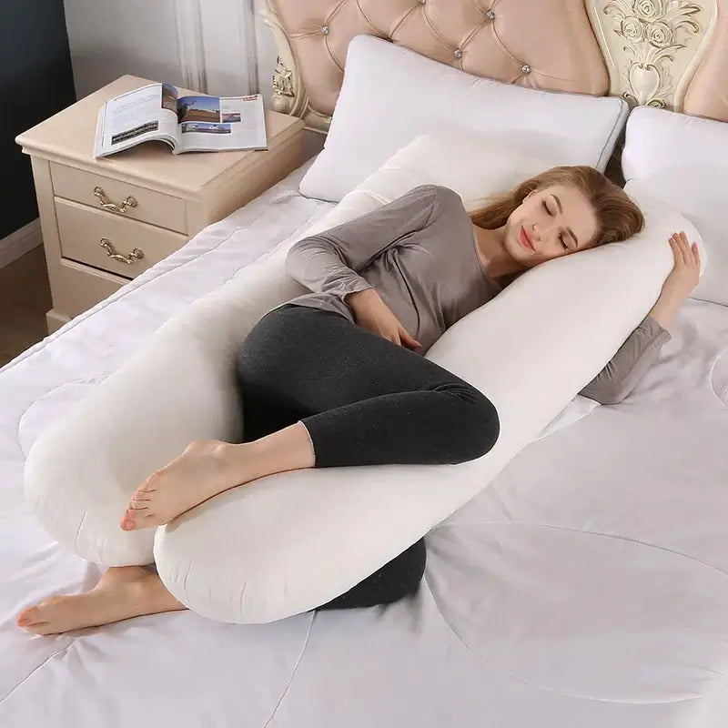 EVEREASE U-shaped full body maternity support pillow in white, cradling a woman resting comfortably on a bed.