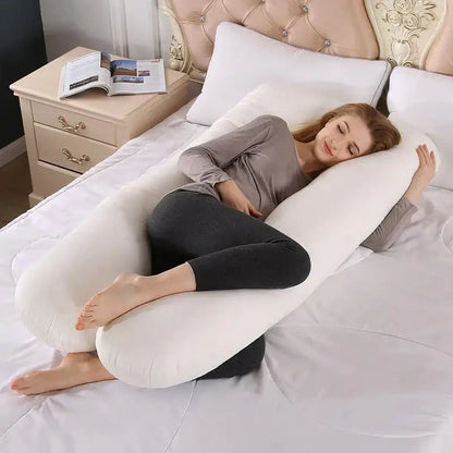 EVEREASE U-shaped full body maternity support pillow in white, cradling a woman resting comfortably on a bed.