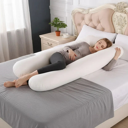 EVEREASE U-shaped full body maternity support pillow in white, cradling a pregnant woman sleeping on a bed.